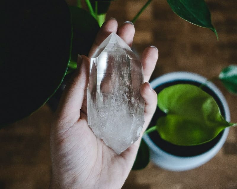 a hand holding a crystal for pain relief